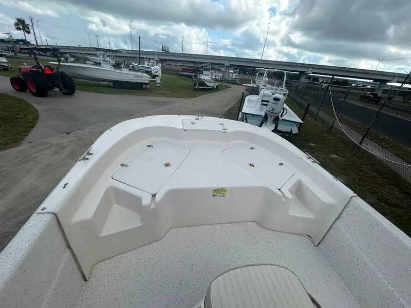 Slide: The Image of 2019 Carolina Skiff 198 DLV boat on a trailer at a marina. - 10