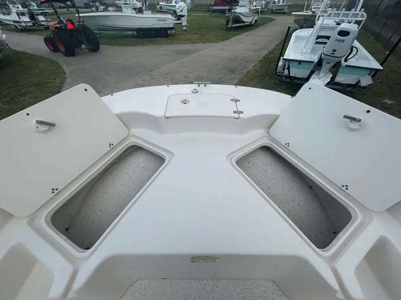 Slide: The Image of 2019 Carolina Skiff 198 DLV boat with open storage compartments. - 11