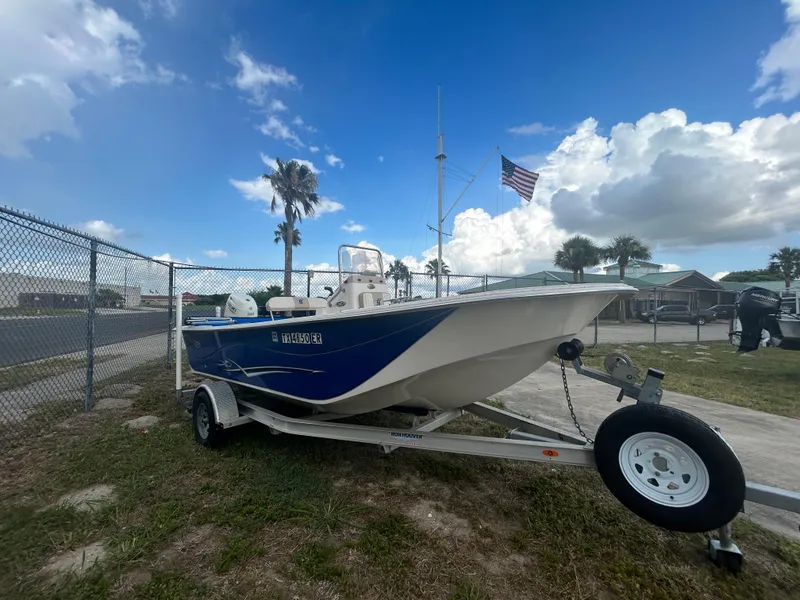 Slide: The Image of 2019 Carolina Skiff 198 DLV boat on trailer with American flag in background. - 4