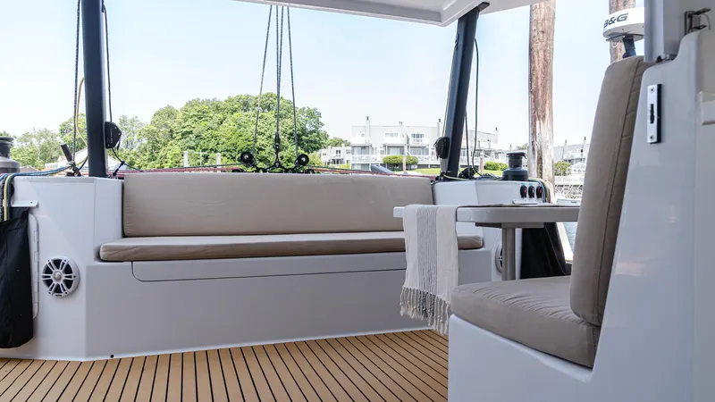Slide: The Image of Modern 2022 Custom Marine 46 yacht interior with seating and wooden deck. - 11