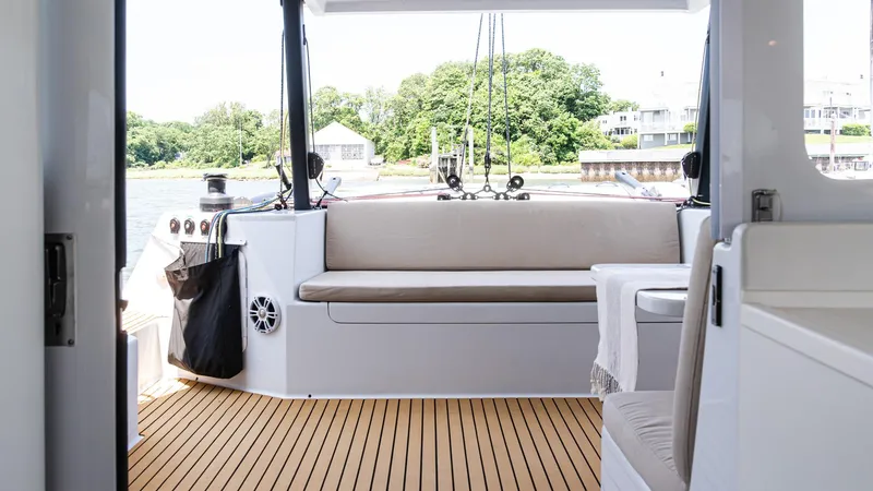 Slide: The Image of Interior view of 2022 Custom Current Marine 46 yacht with wooden deck and seating area. - 12