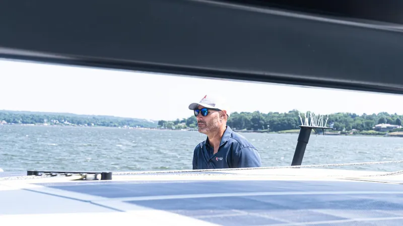 Slide: The Image of Man sailing on 2022 Custom Current Marine 46 yacht, wearing sunglasses, on a sunny day. - 14
