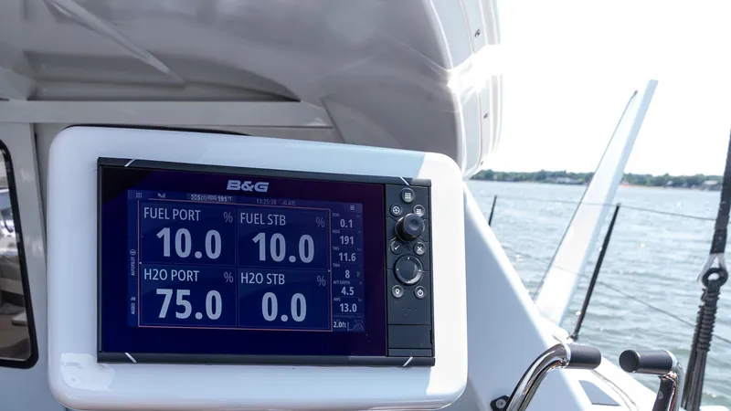 Slide: The Image of Marine navigation display on Custom Current Marine 46, 2022 model, showing fuel and water levels. - 17