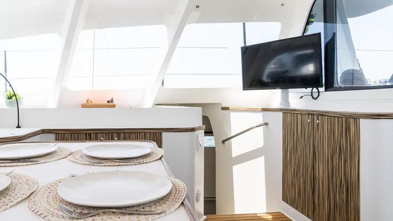 Slide: The Image of Luxurious interior of 2022 Custom Current Marine 46 yacht with dining area and TV. - 24