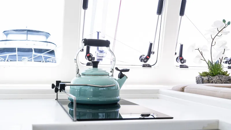 Slide: The Image of Teal kettle on stove in Custom Current Marine 46 yacht kitchen, 2022 model. - 29