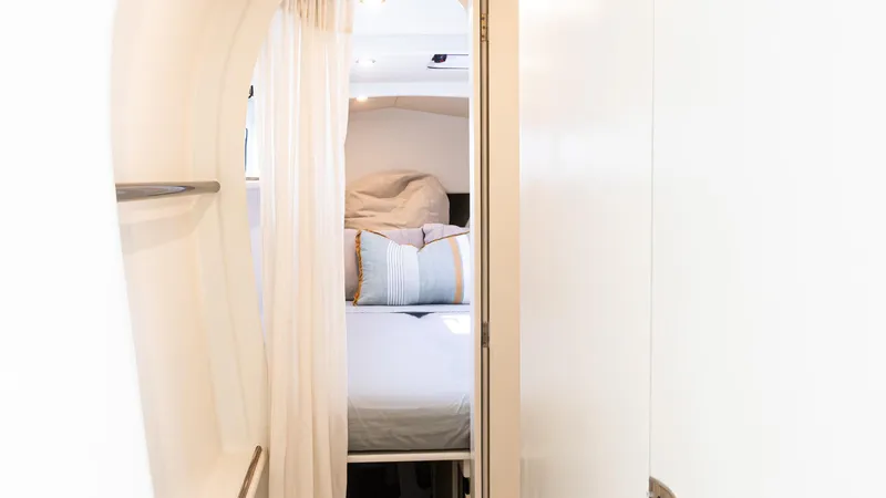 Slide: The Image of Interior cabin of 2022 Custom Current Marine 46 yacht, featuring cozy bedding and modern design. - 34