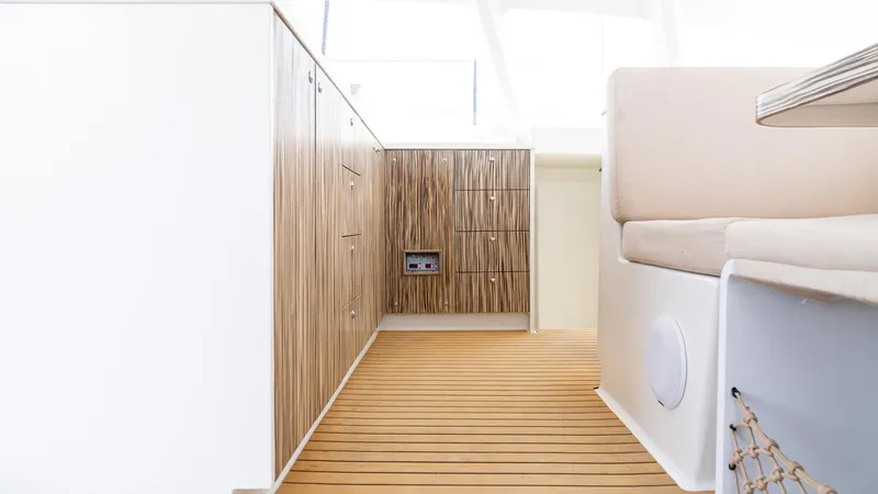 Slide: The Image of Modern interior of 2022 Custom Current Marine 46 yacht with wood paneling and seating. - 36