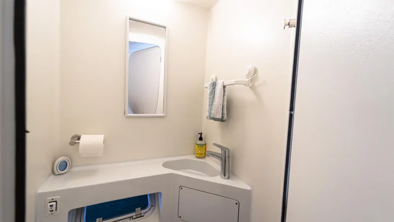 Slide: The Image of Modern bathroom in 2022 Custom Current Marine 46 yacht, featuring sleek sink and mirror. - 41