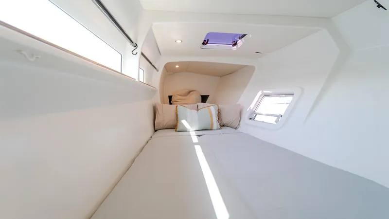 Slide: The Image of Interior cabin of 2022 Custom Current Marine 46 yacht, featuring cozy bedding and natural light. - 45
