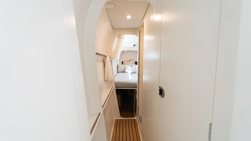 Slide: The Image of Interior hallway of 2022 Custom Current Marine 46 yacht, featuring modern design and cozy cabin. - 46