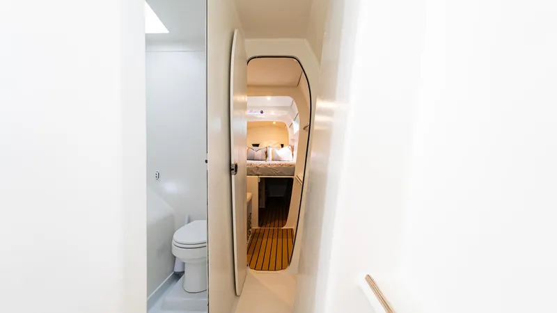 Slide: The Image of Interior of 2022 Custom Current Marine 46 yacht, featuring modern bathroom and cozy cabin. - 49