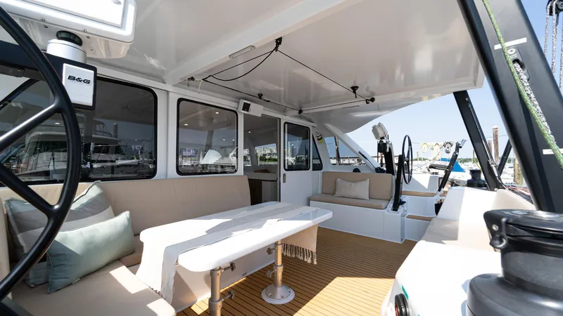 Slide: The Image of Spacious interior of 2022 Custom Current Marine 46 yacht with seating and table. - 6