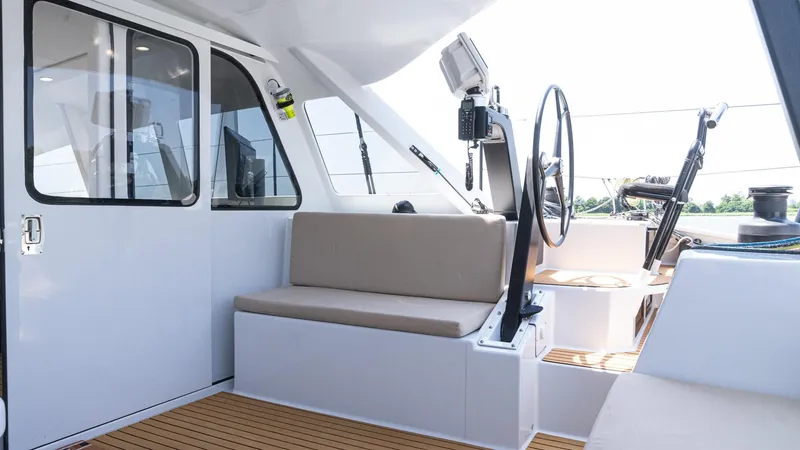 Slide: The Image of Custom Current Marine 46 yacht interior, 2022 model, featuring seating and steering wheel. - 8