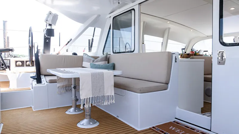 Slide: The Image of Luxurious 2022 Custom Current Marine 46 yacht interior with elegant seating and dining area. - 9