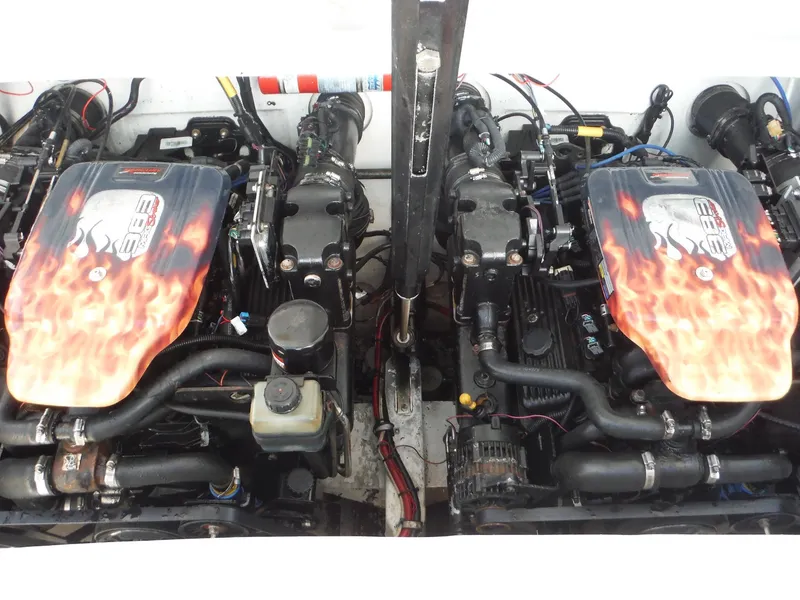 Slide: The Image of Twin engines of a 1999 Baja 29 Outlaw boat with flame decals. - 20