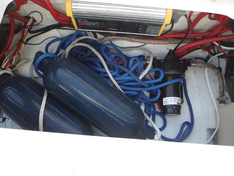 Slide: The Image of 1999 Baja 29 Outlaw boat storage with ropes, fenders, and equipment. - 24