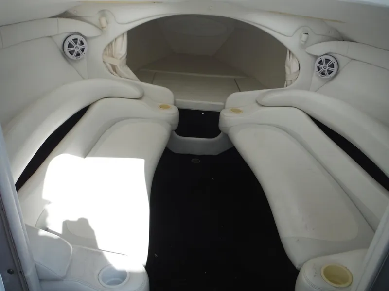 Slide: The Image of 1999 Baja 29 Outlaw boat interior with white seating and speaker system. - 29