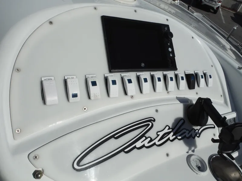 Slide: The Image of Dashboard of 1999 Baja 29 Outlaw boat with control switches and display. - 33