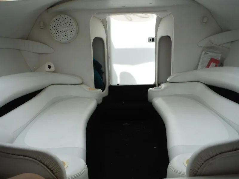 Slide: The Image of Interior of 1999 Baja 29 Outlaw boat with white seating and modern design. - 35