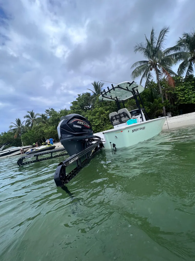 Slide: The Image of 2022 Sportsman Masters 227 Bay Boat docked near tropical beach. - 2