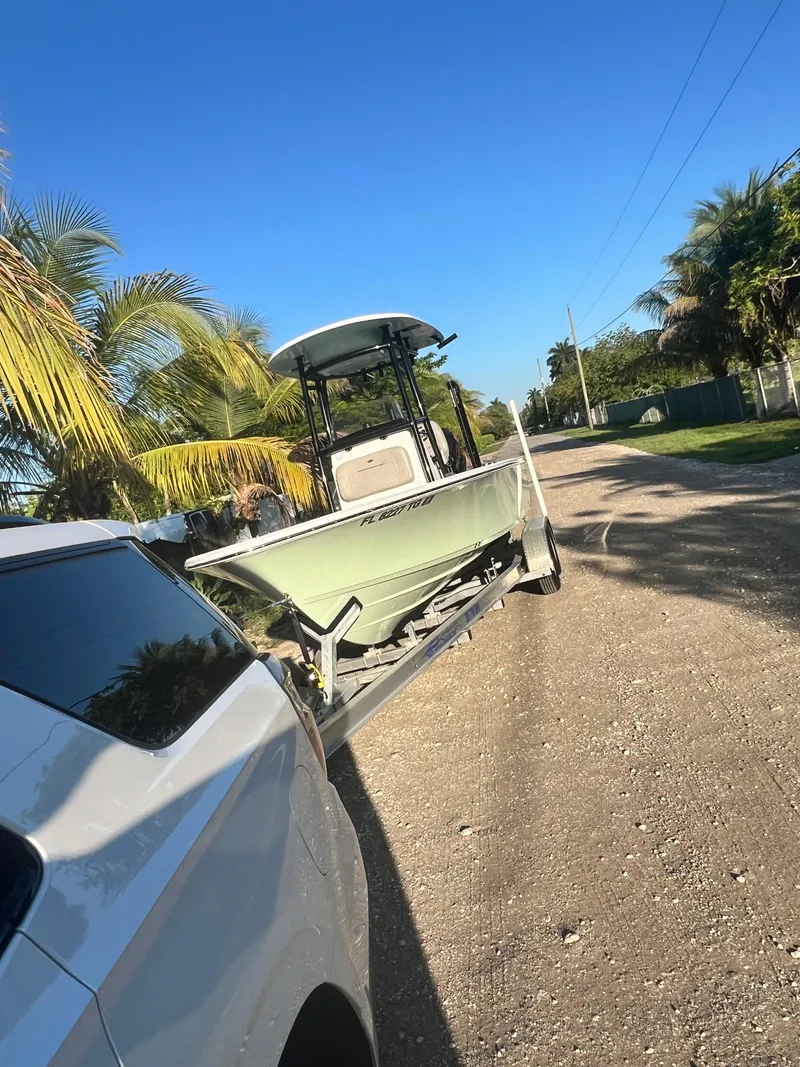 Slide: The Image of 2022 Sportsman Masters 227 Bay Boat on trailer, towed by white vehicle. - 5
