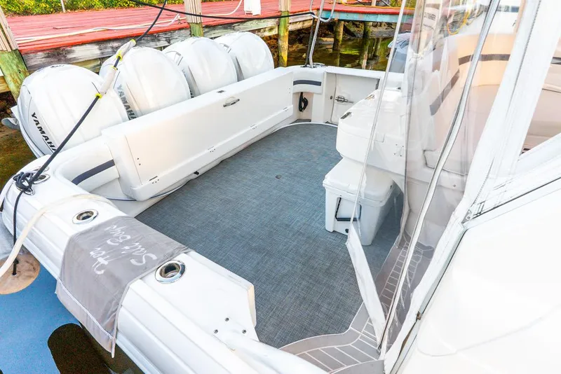 Slide: The Image of 2019 Intrepid 475 Sport Yacht with Yamaha engines, docked, featuring spacious deck area. - 45