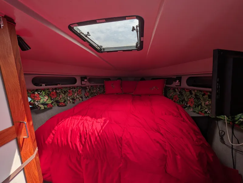 Slide: The Image of Cozy cabin interior of 1987 Cruisers 3370 Esprit with red bedding and floral accents. - 14