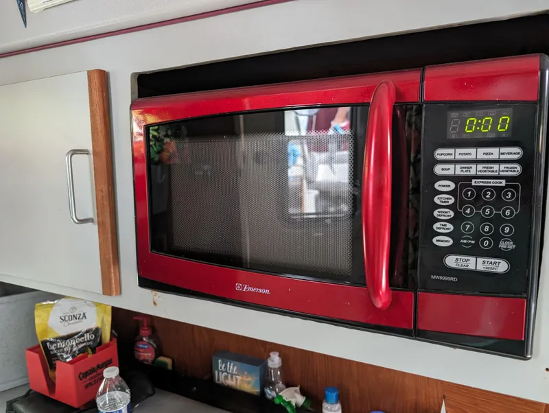 Slide: The Image of Red microwave in the kitchen of a 1987 Cruisers 3370 Esprit boat. - 9