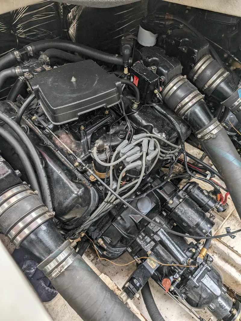Slide: The Image of 1987 Cruisers 3370 Esprit engine compartment with visible hoses and wiring. - 13