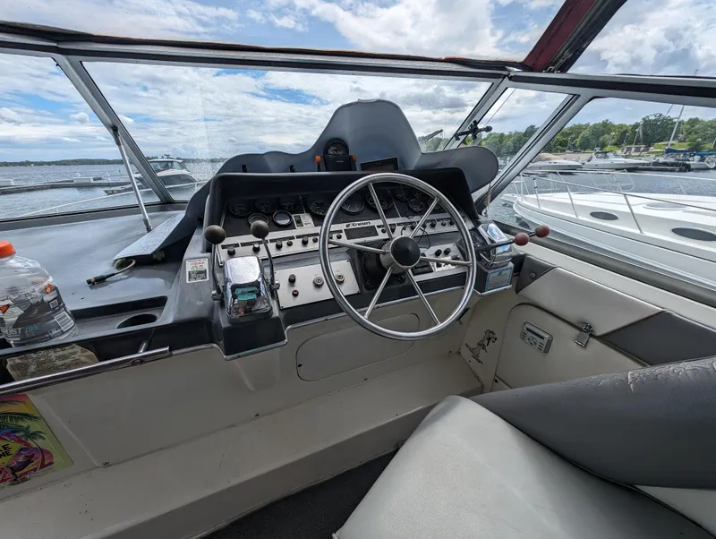 Slide: The Image of 1987 Cruisers 3370 Esprit boat helm with steering wheel and control panel. - 7