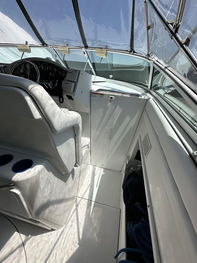 Slide: The Image of 1997 Chris-Craft 380 Continental B cockpit with white interior and steering console. - 12