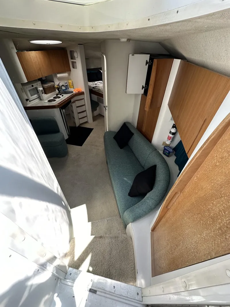 Slide: The Image of 1997 Chris-Craft 380 Continental B interior with kitchen, seating area, and bedroom. - 13