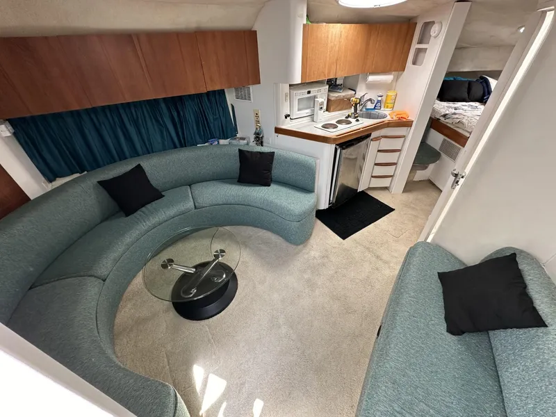 Slide: The Image of 1997 Chris-Craft 380 Continental B interior with curved seating, kitchenette, and bedroom. - 14