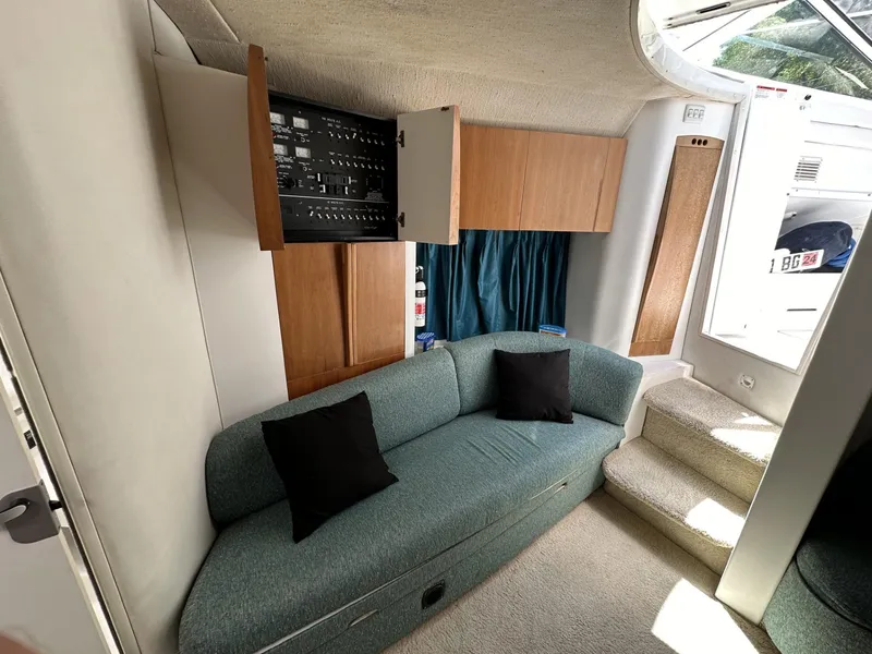 Slide: The Image of 1997 Chris-Craft 380 Continental B interior with teal sofa and control panel. - 15