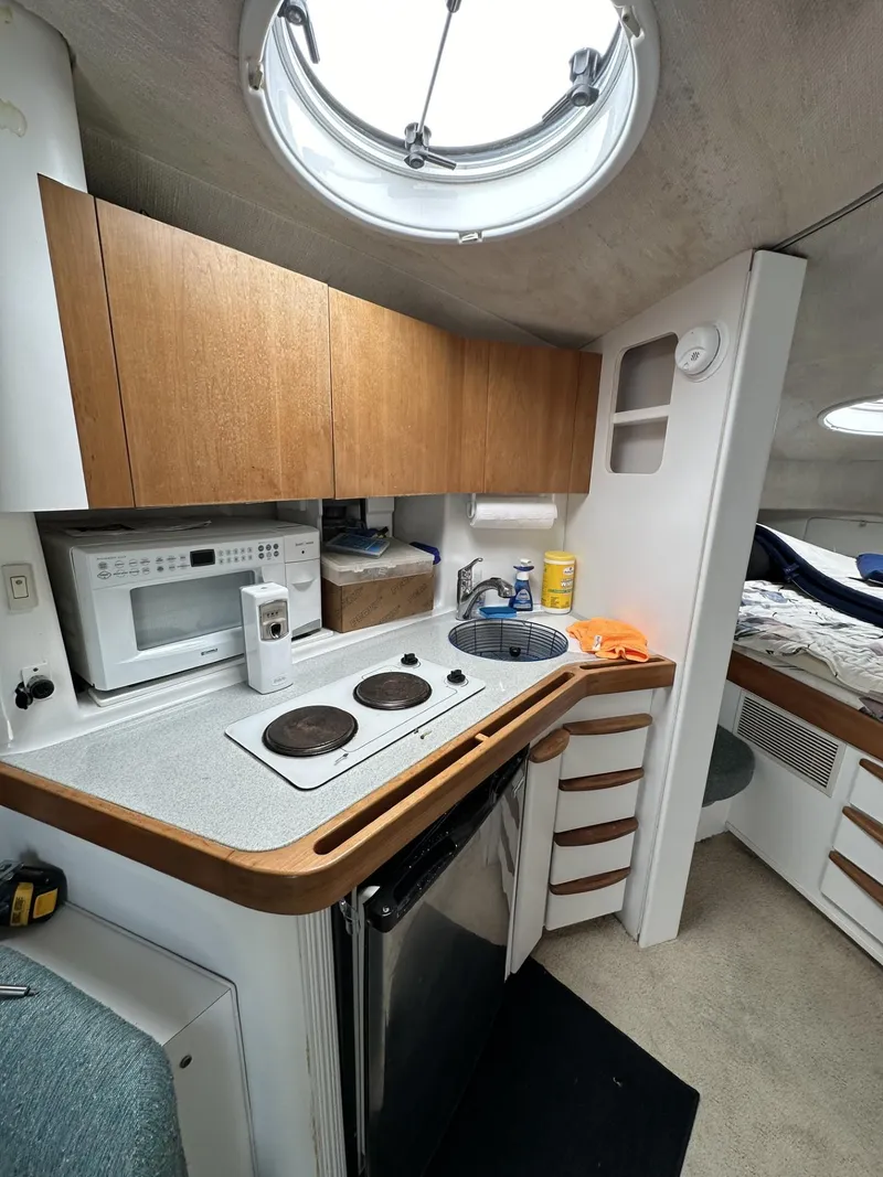 Slide: The Image of 1997 Chris-Craft 380 Continental B boat interior kitchen with stove, microwave, and sink. - 16