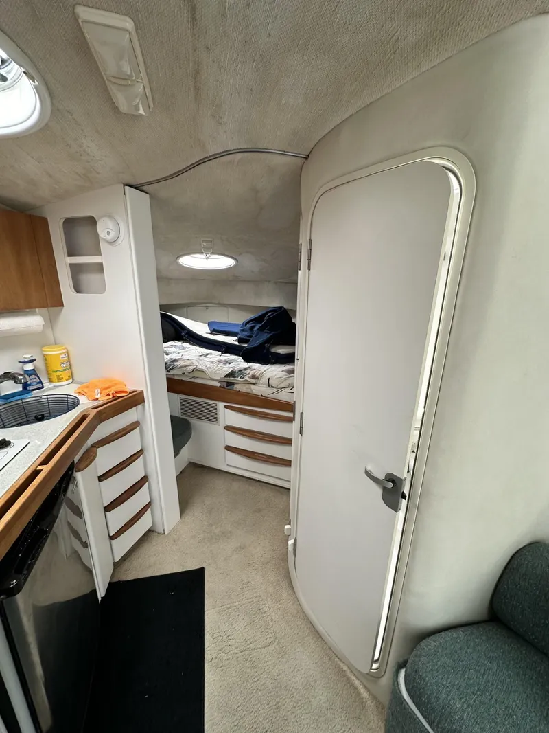 Slide: The Image of 1997 Chris-Craft 380 Continental B interior cabin with bed, kitchenette, and storage. - 18