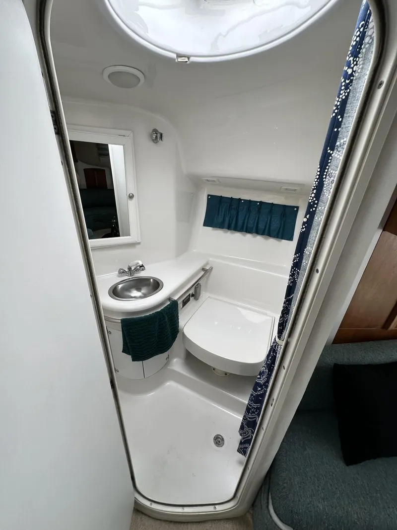 Slide: The Image of 1997 Chris-Craft 380 Continental B boat bathroom with sink and mirror. - 19