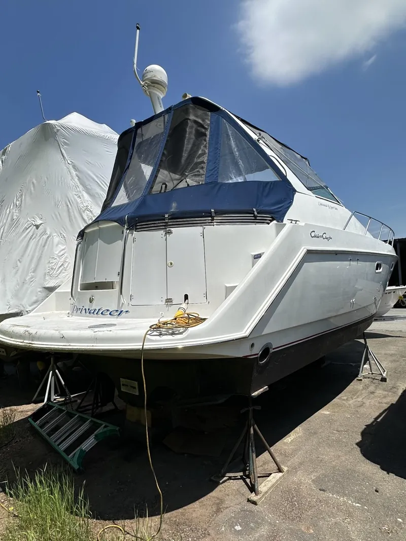 Slide: The Image of 1997 Chris-Craft 380 Continental B boat on stands, covered with a blue tarp. - 2