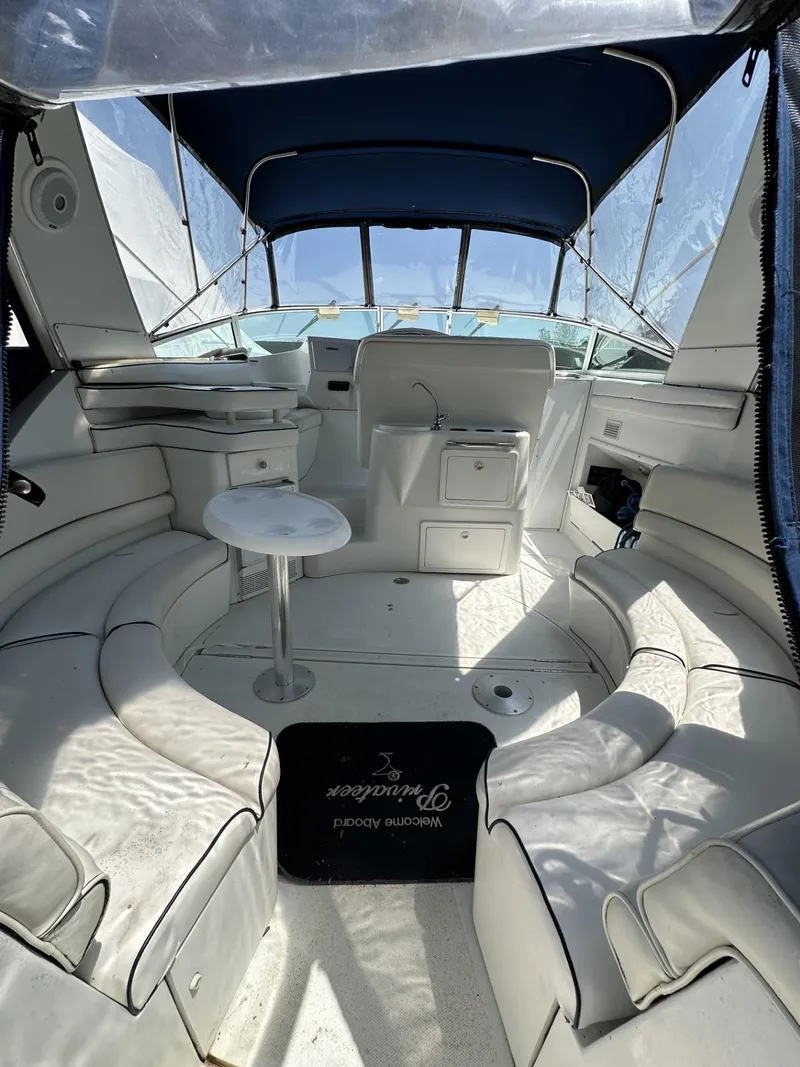 Slide: The Image of 1997 Chris-Craft 380 Continental B interior with white seating and blue canopy. - 4