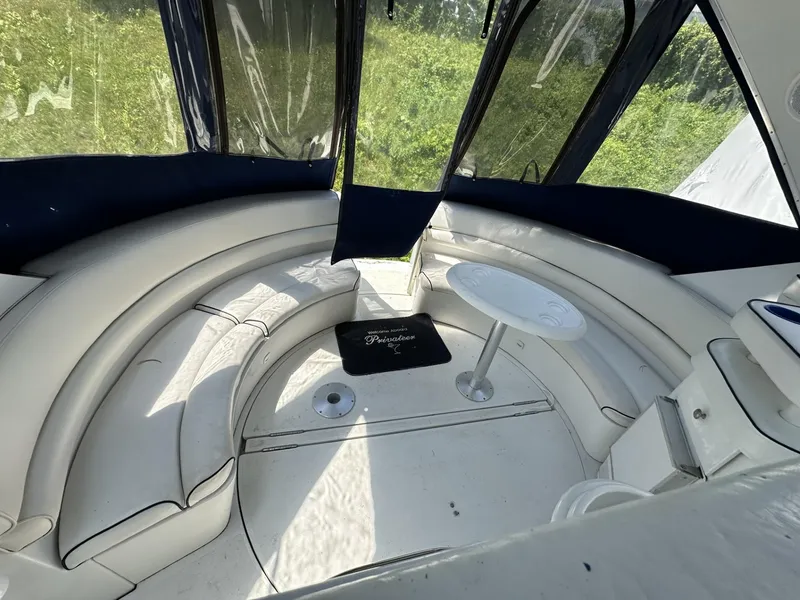 Slide: The Image of 1997 Chris-Craft 380 Continental B interior with curved seating and small table. - 5