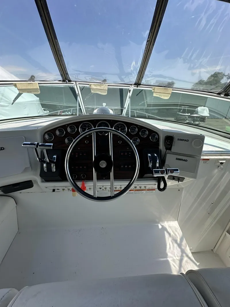 Slide: The Image of 1997 Chris-Craft 380 Continental B boat helm with steering wheel and instrument panel. - 9