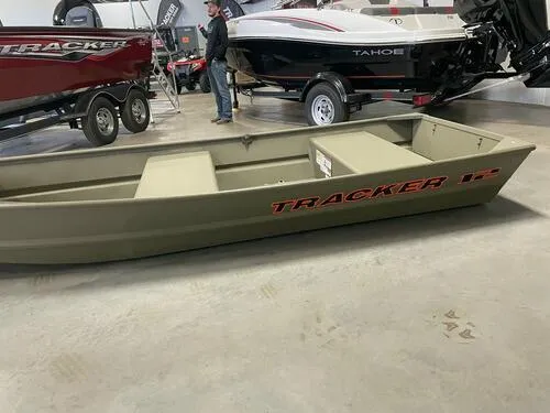Slide: The Image of 2024 Tracker Grizzly 1236 Jon boat displayed in a showroom. - 3
