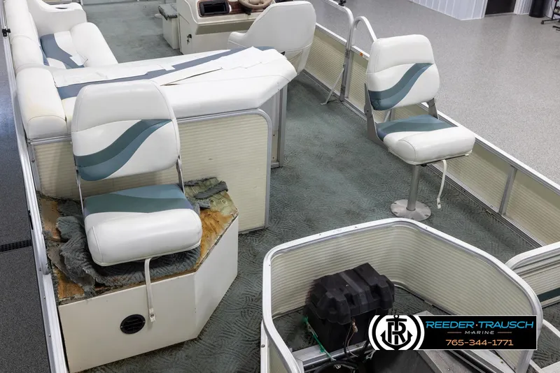 Slide: The Image of 2002 Suncruiser Trinidad 224 pontoon boat interior with seating and control console. - 11
