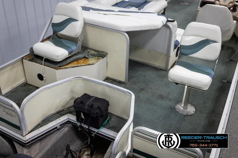 Slide: The Image of 2002 Suncruiser Trinidad 224 boat interior with seating and battery compartment. - 12