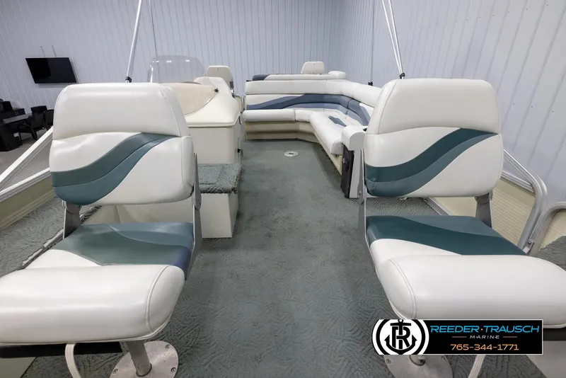 Slide: The Image of 2002 Suncruiser Trinidad 224 pontoon boat interior with white and teal seating. - 13