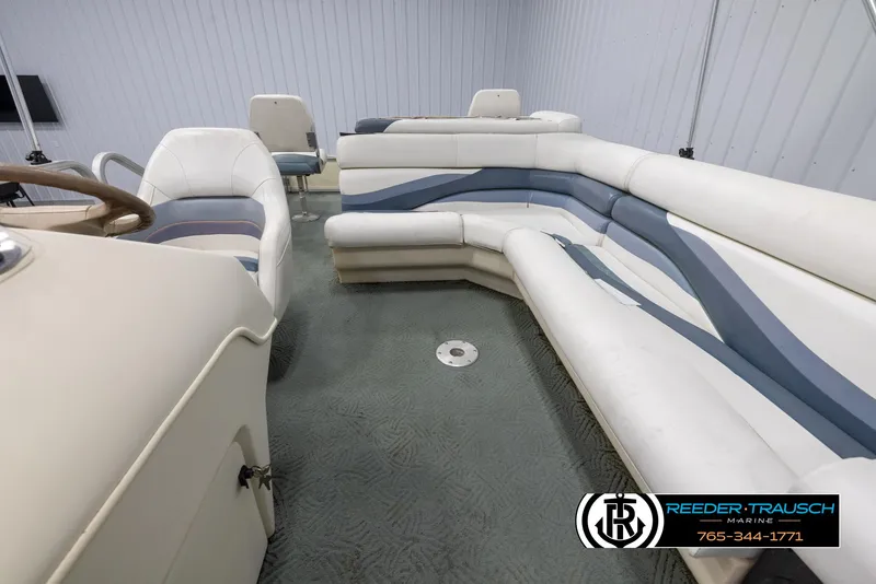Slide: The Image of 2002 Suncruiser Trinidad 224 pontoon boat interior with white and blue seating. - 14