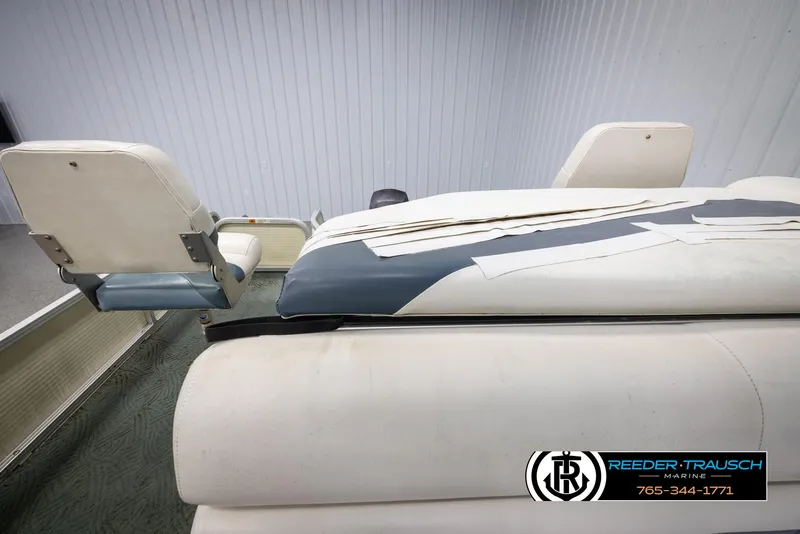 Slide: The Image of 2002 Suncruiser Trinidad 224 boat interior with worn white and blue seating. - 15