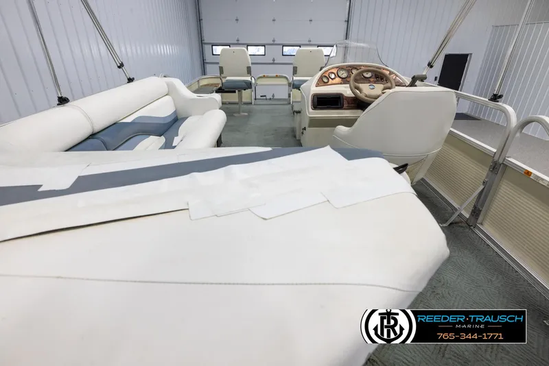 Slide: The Image of 2002 Suncruiser Trinidad 224 pontoon boat interior with white and blue seating. - 16