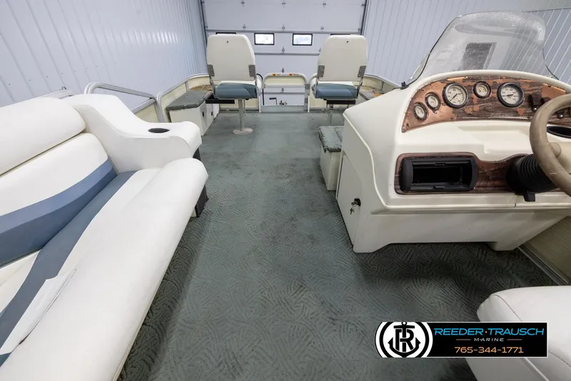 Slide: The Image of Interior of a 2002 Suncruiser Trinidad 224 pontoon boat with seating and control console. - 17