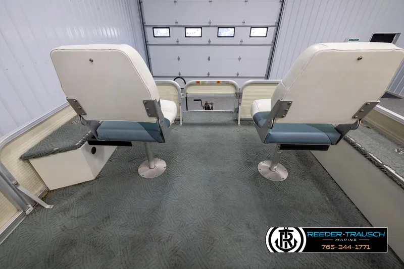 Slide: The Image of 2002 Suncruiser Trinidad 224 boat interior with two swivel seats in a garage. - 18